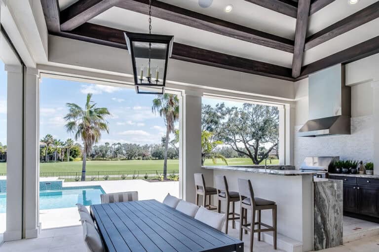 Outdoor living space at a home in Palmer Ranch overlooking the in-ground pool