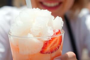 Closeup of woman holding frozen strawberry cocktail