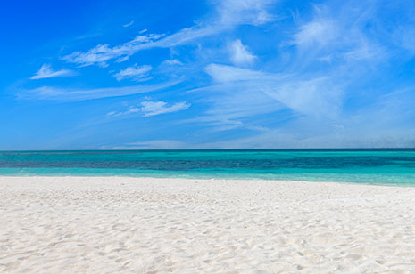 White sand beach with blue sky.